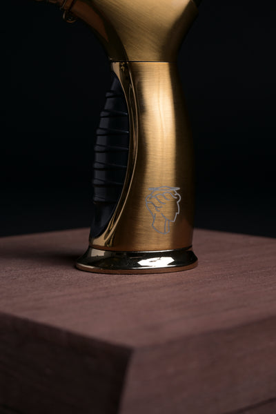 Close-up of Helius Originals luxury gold torch on handcrafted wood box, premium cocktail smoker accessory for mixology and home bars