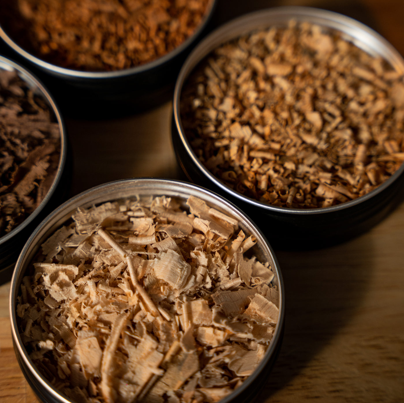 Assorted tins of 100% reclaimed Ontario hardwood smoking shavings for cocktails and culinary dishes, eco-luxury barware accessory